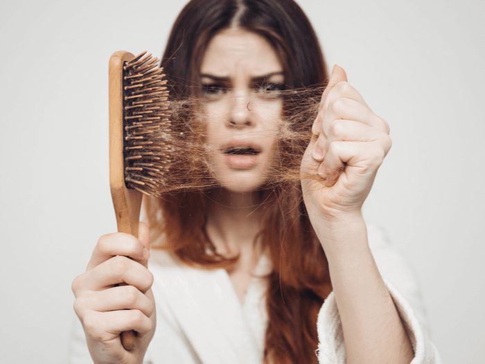 Photo highlighting the impact of female hair loss with visible thinning on the scalp.